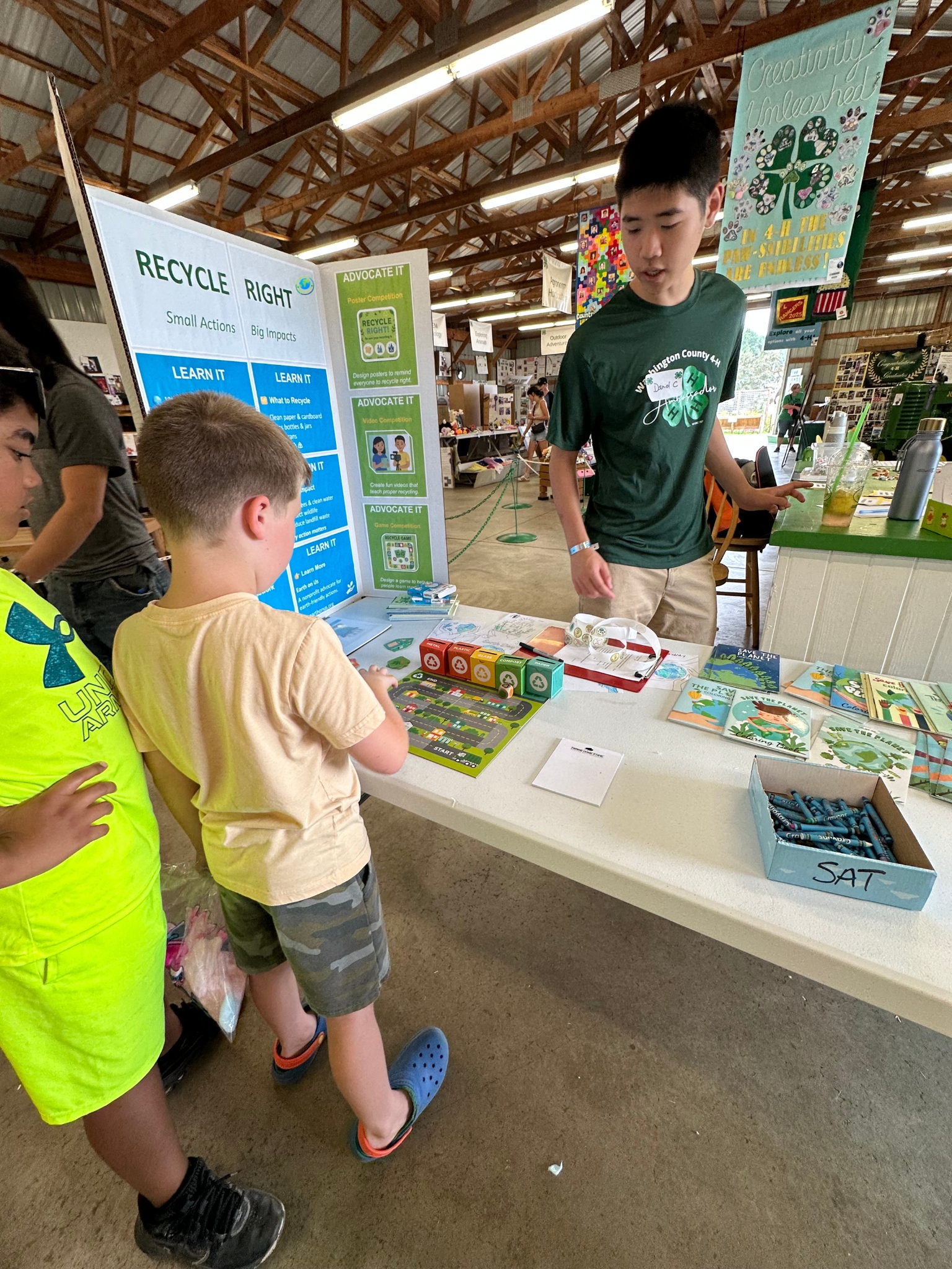 Recycle Right trifold poster board and pledge banner at the Earth on Us booth