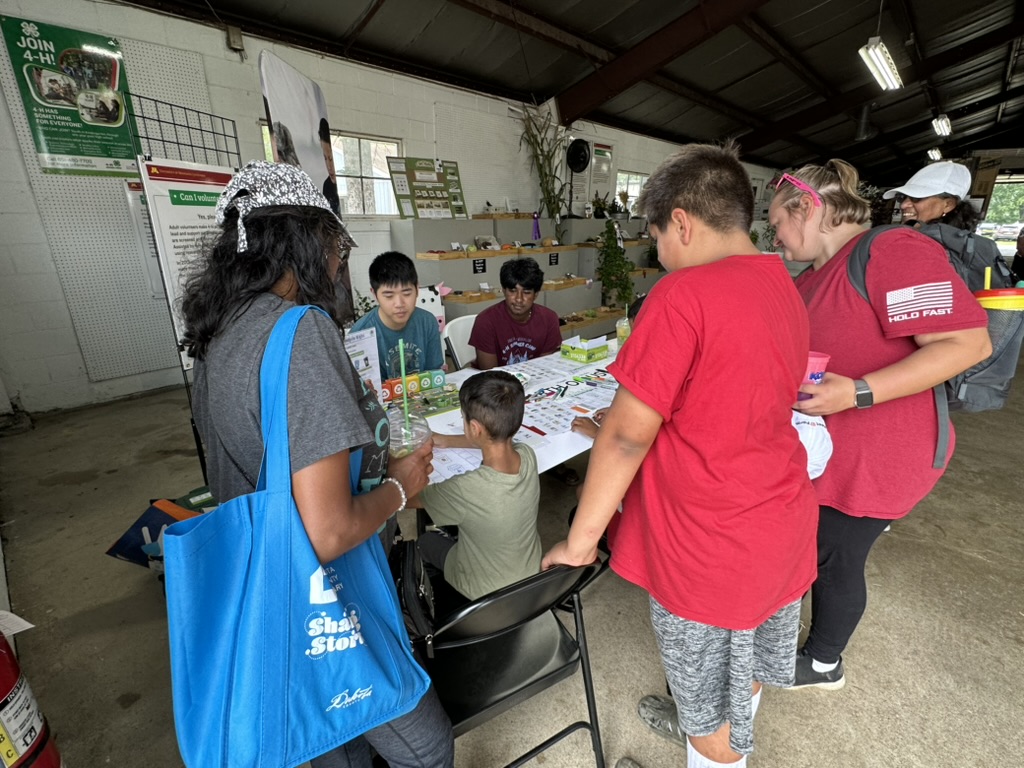 Families gathered around the Earth on Us table at the Dakota County Fair